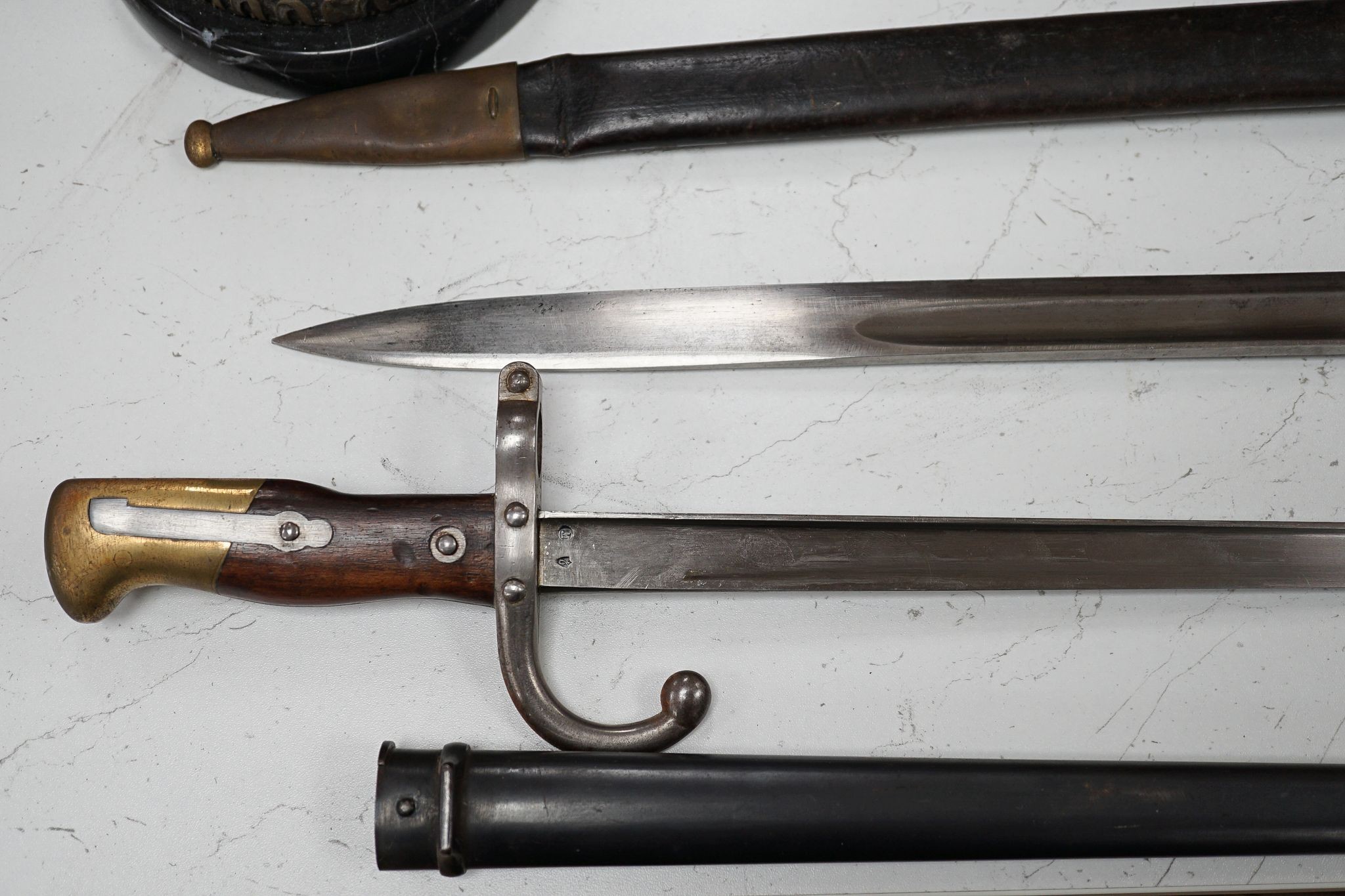 A French bayonet and scabbard with matching serial number (38804) and inscription and date to back of blade (1879) and another Solingen bayonet and scabbard